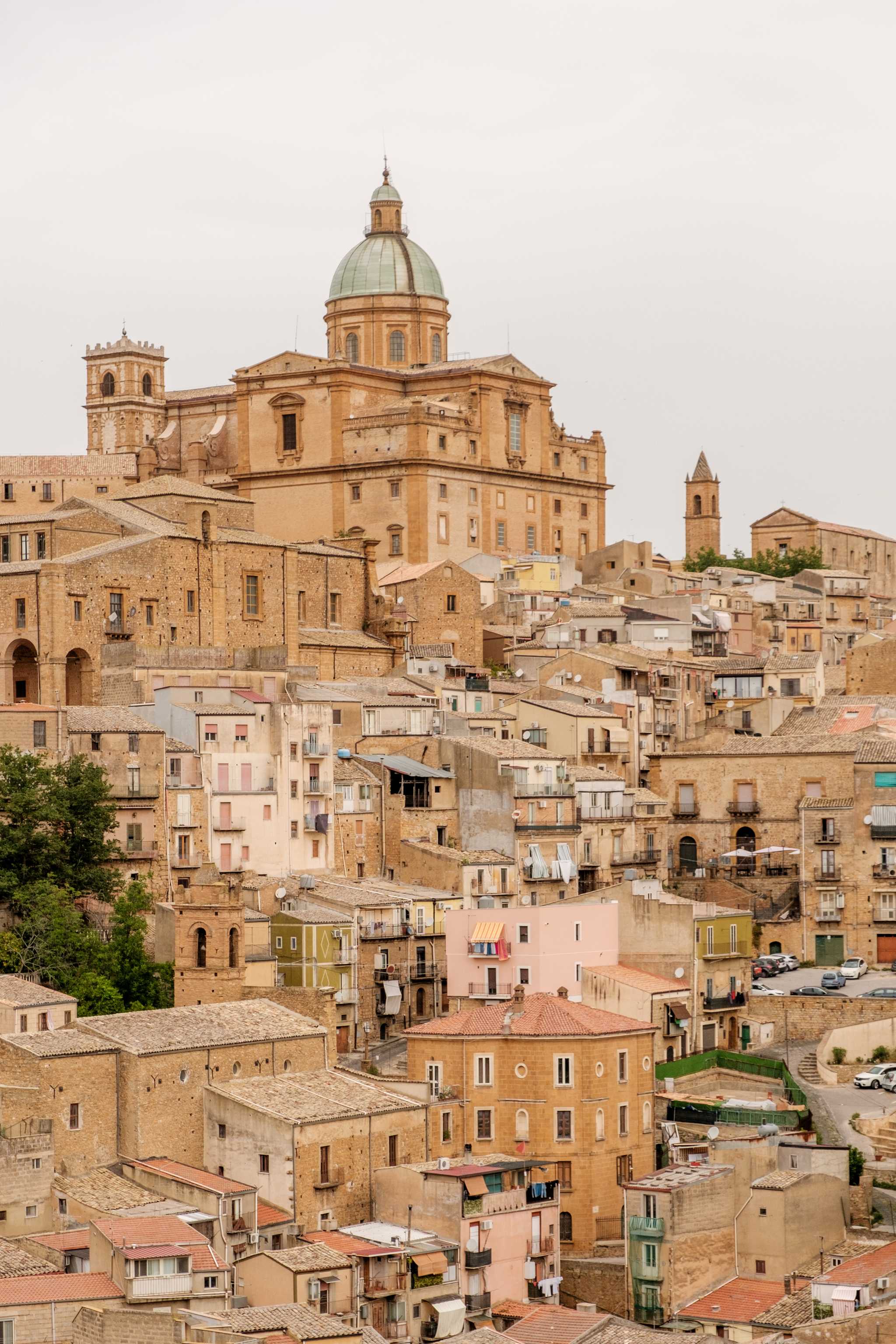 Piazza Armerinaâs light brown buildings, focused on the high Green-domed cathedral.