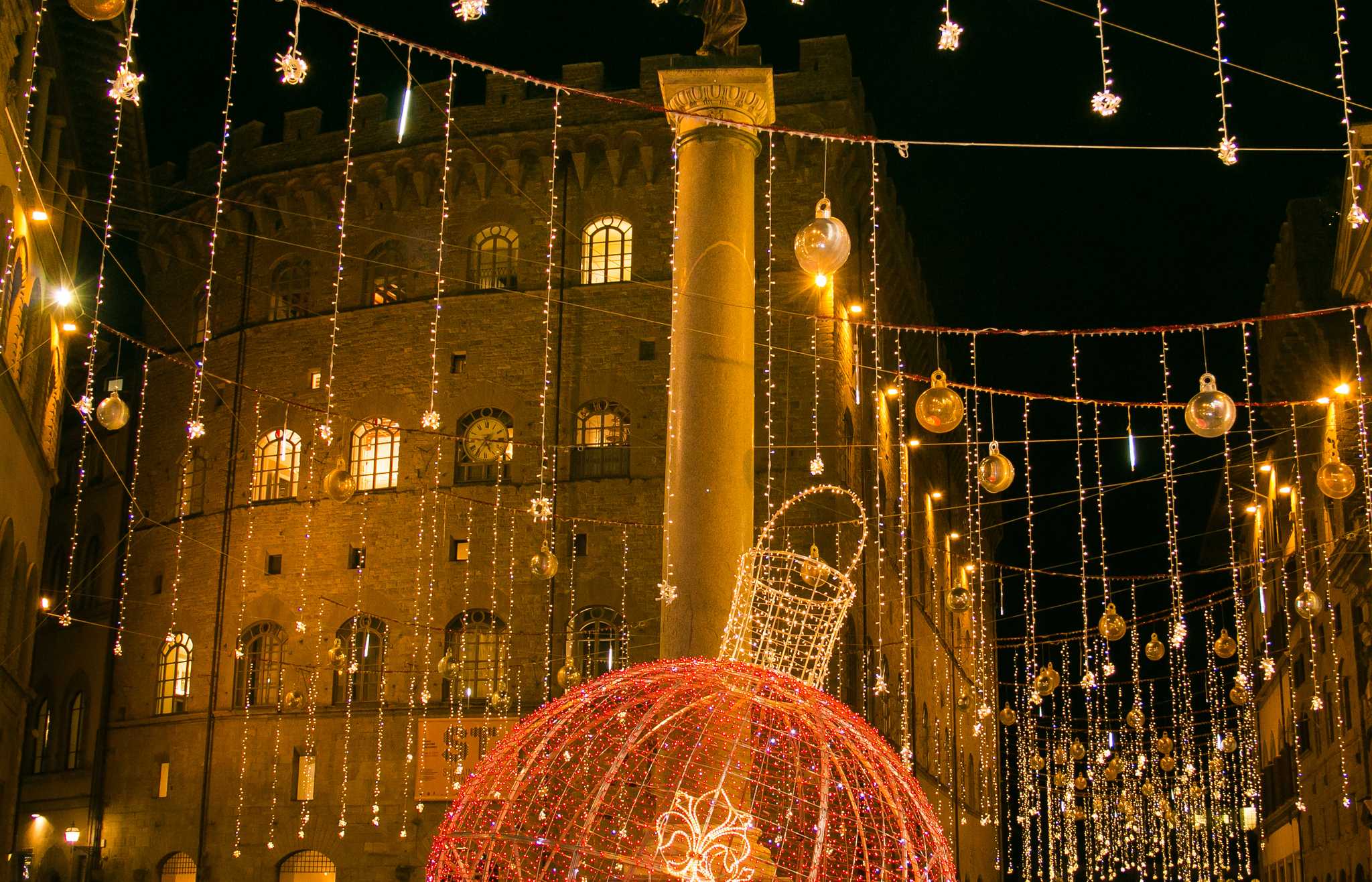 Christmas lights and a giant red bauble in Santa Trinita Square, Florence.