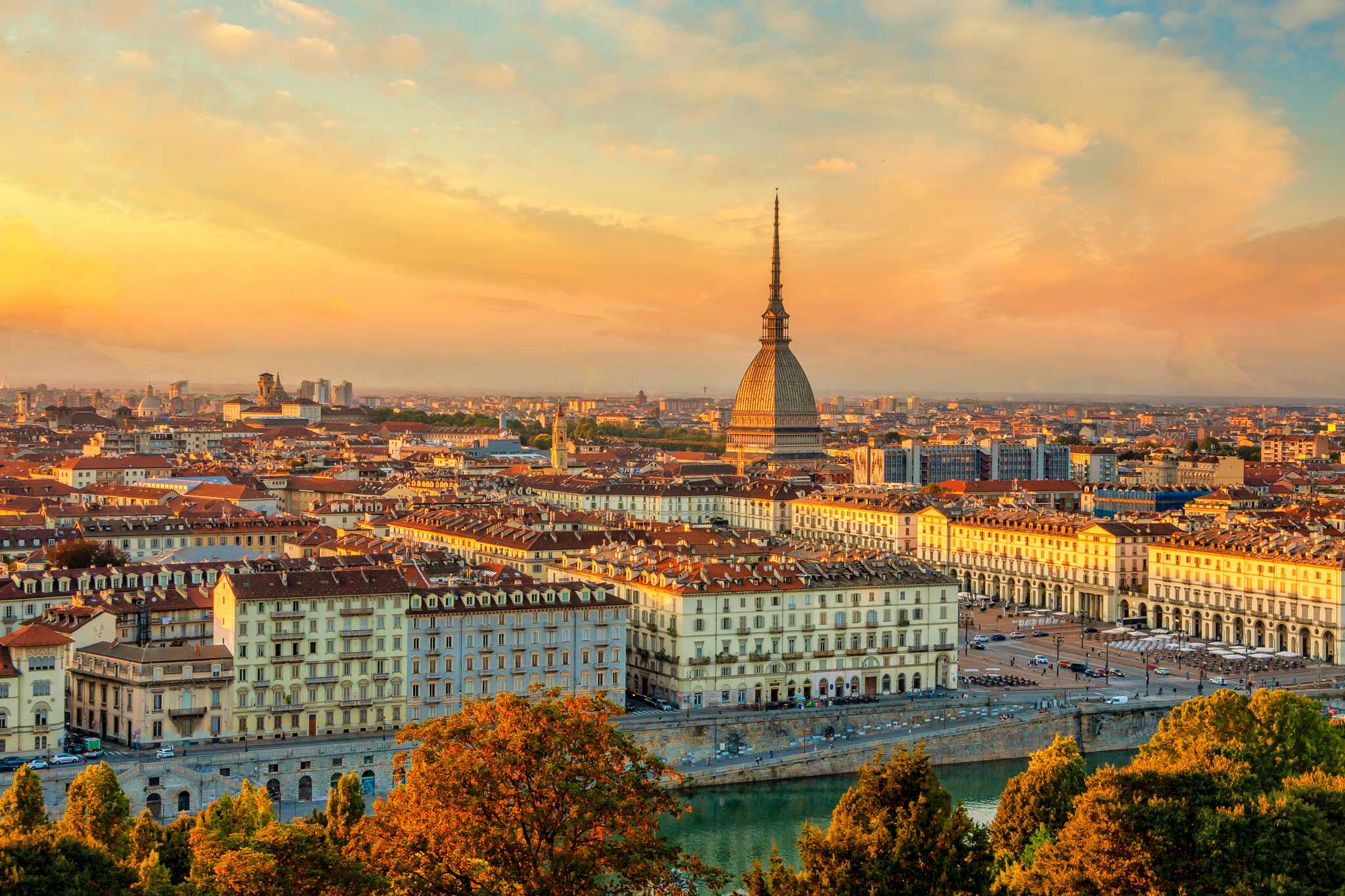 Late autumn view over Turin with the Mole Antonelliana and the Alps at sunset.