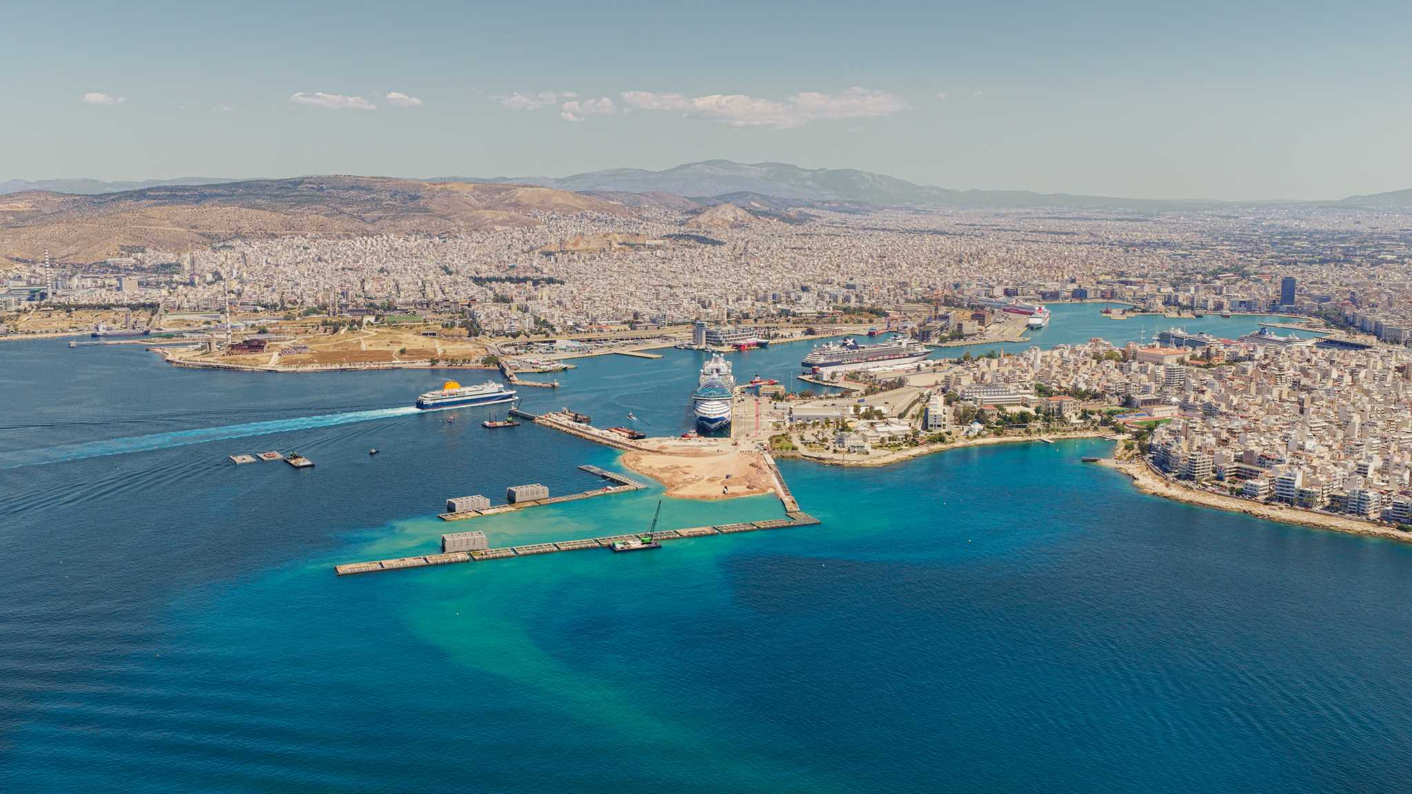 The Piraeus cruise port from above, with several huge cruise ships docked and sailing.