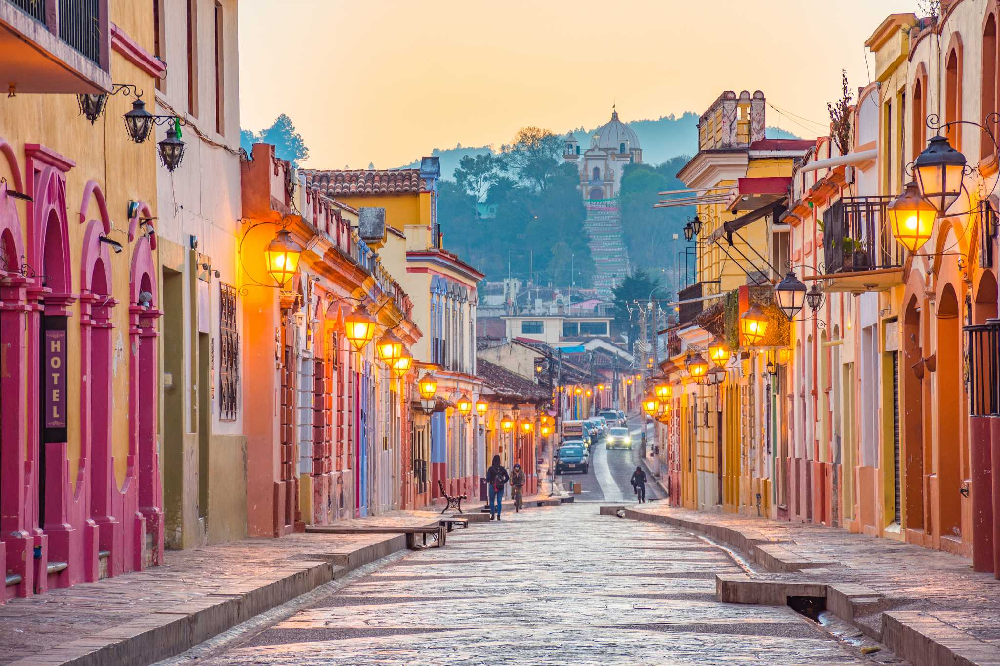 Lantern-lit pedestrian street in San Cristóbal de las Casas leading to Guadalupe church.