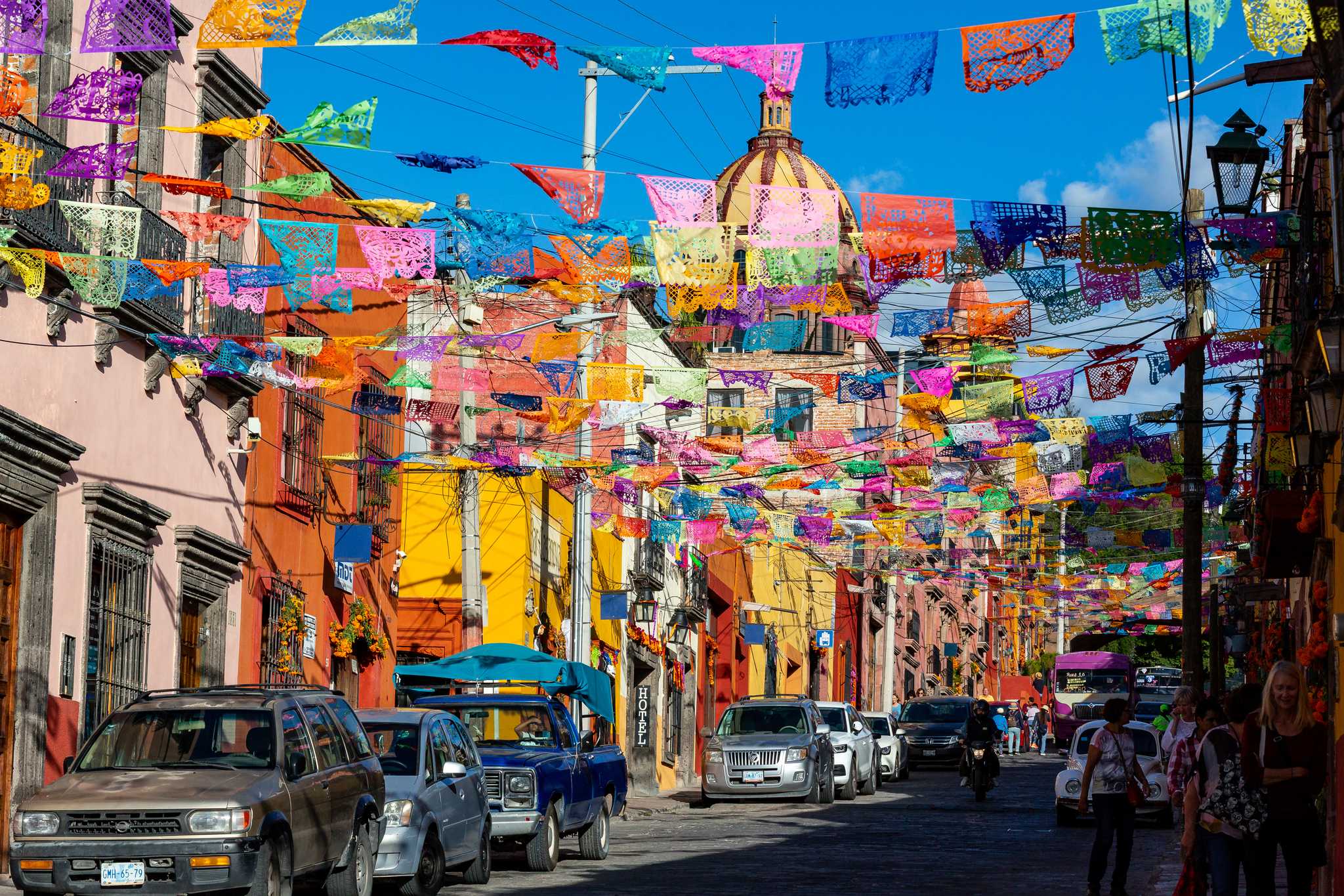 Paper banners strewn across a city street in San Miguel de Allende for a festival.