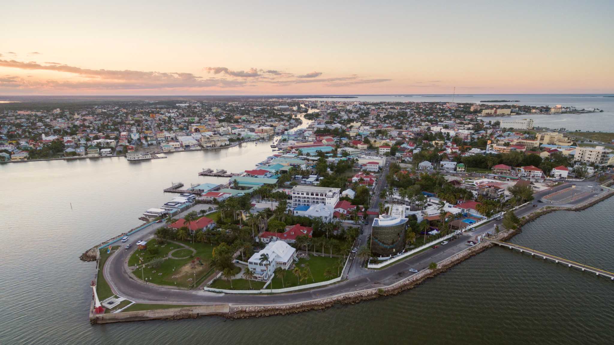 Aerial view of Belize City's Fort Point and Haulover Creek at sunset.