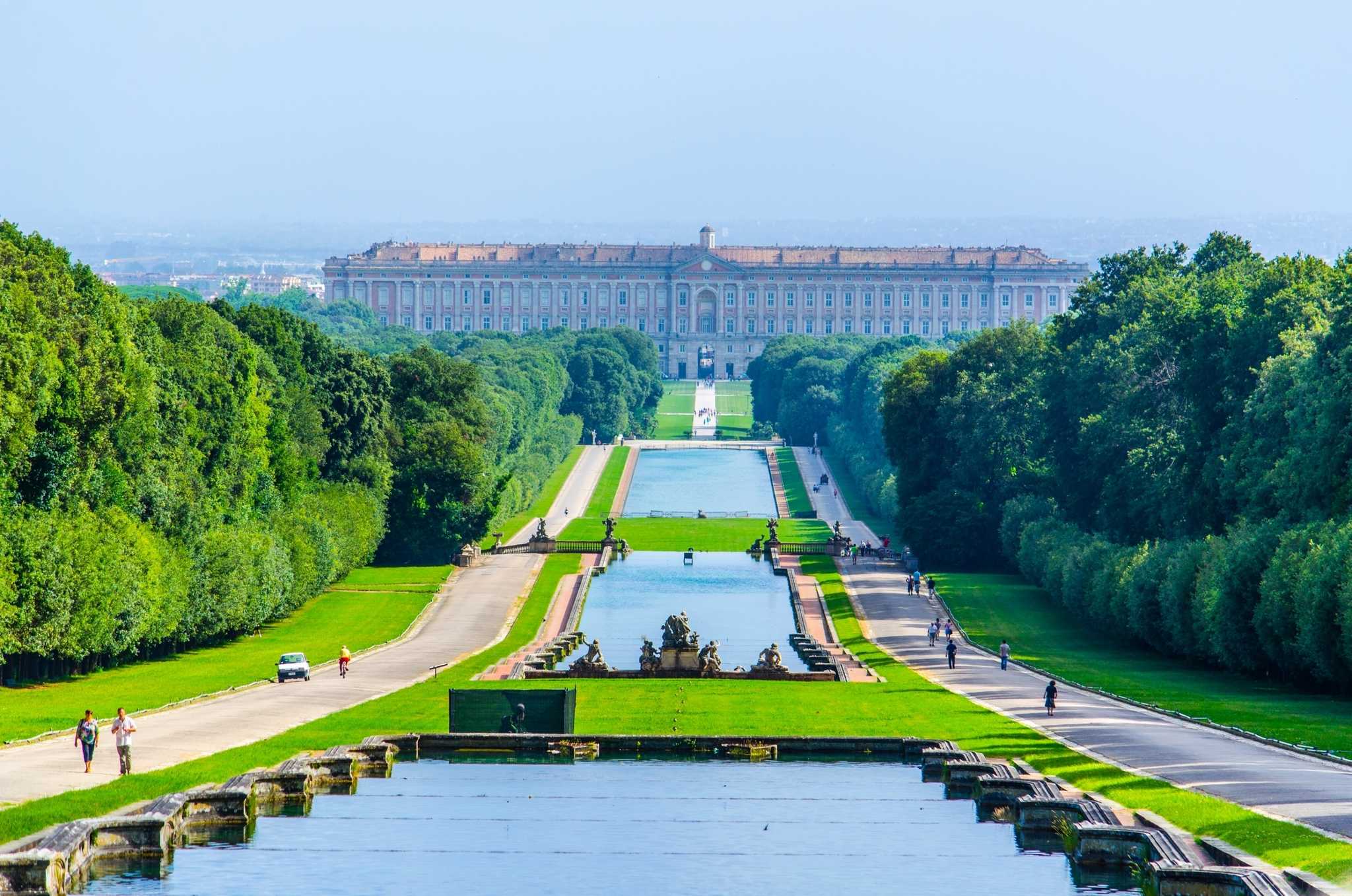 Long gardens of the Royal Palace of Caserta, pools and fountains leading to the palace behind.