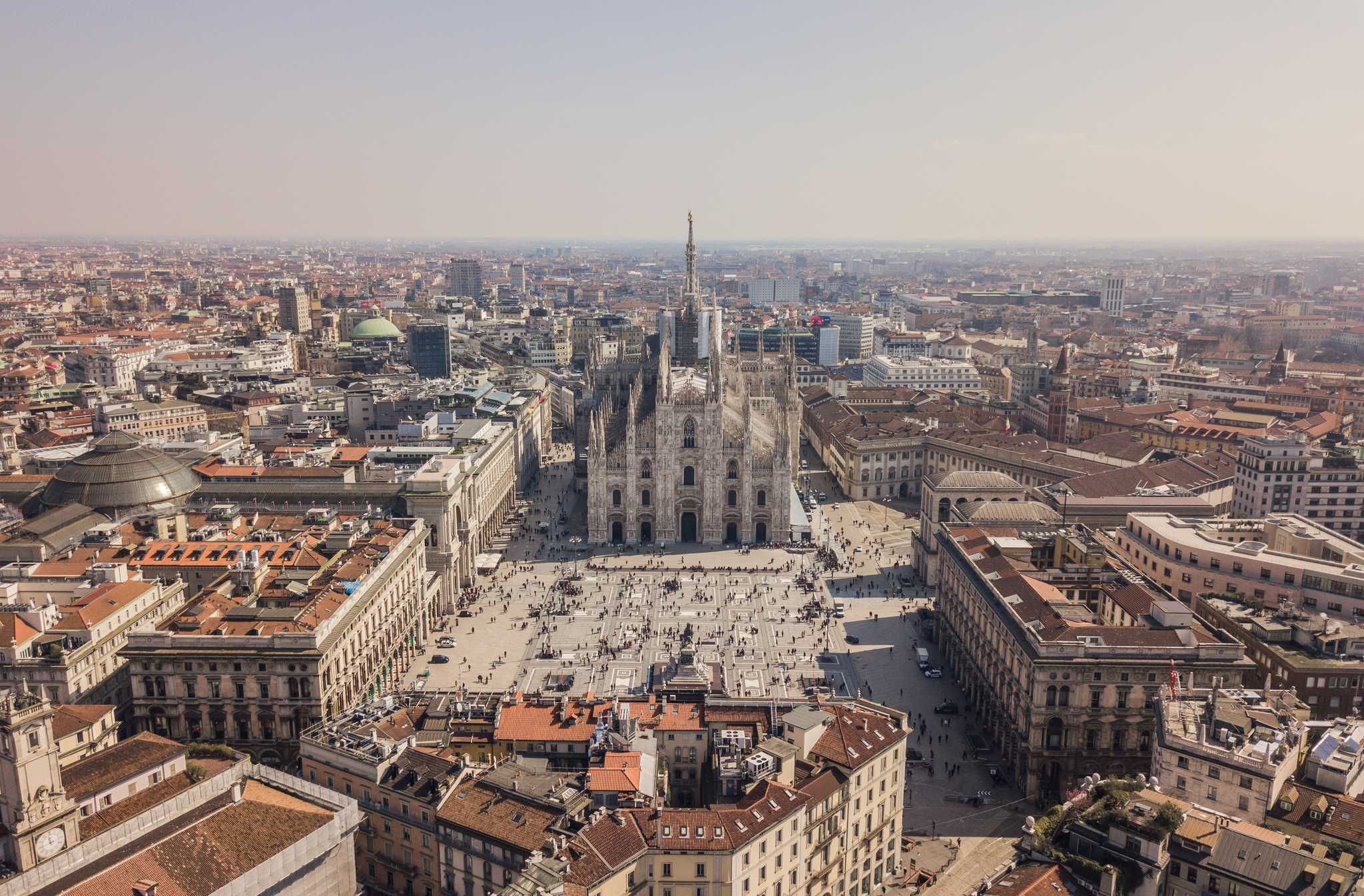 Milan’s Piazza del Duomo, as seen from above, as the city stretches in all directions.