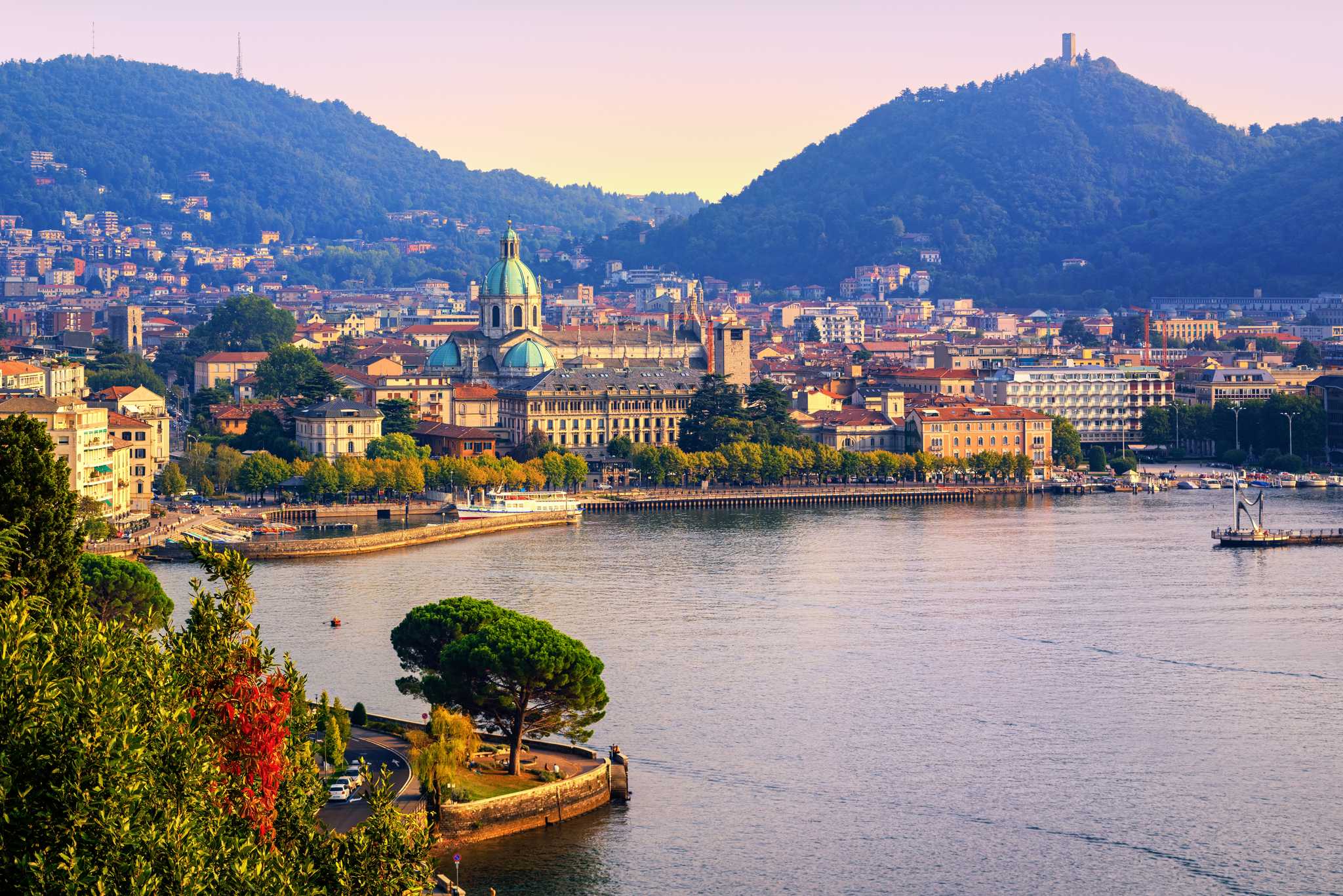 The city of Como and its cathedral dome spread along the Lake Como waterfront.