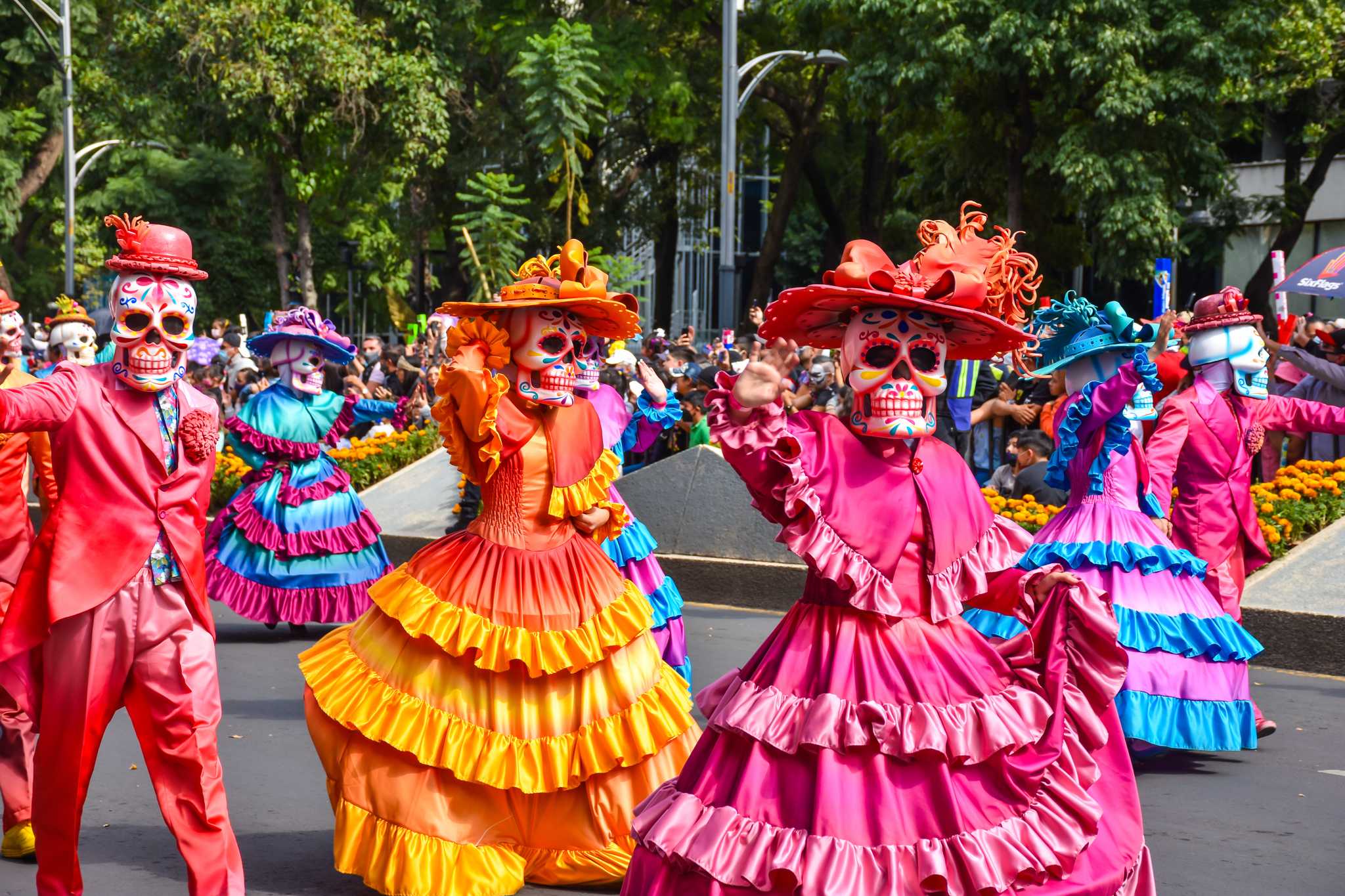 Dancers in skull masks and ruffled gowns at Mexico City’s Day of the Dead parade.