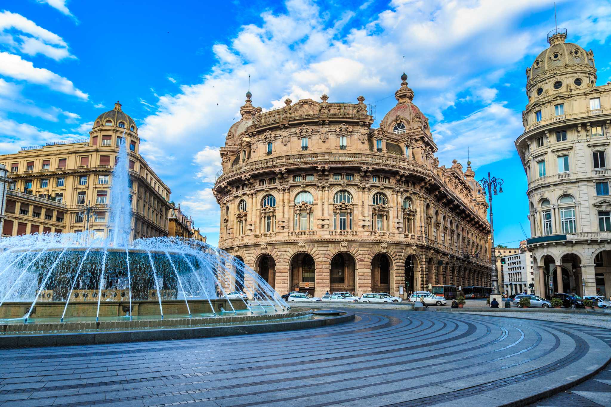 Fountain in Genoa's Piazza De Ferrari before the grand stock exchange palace.