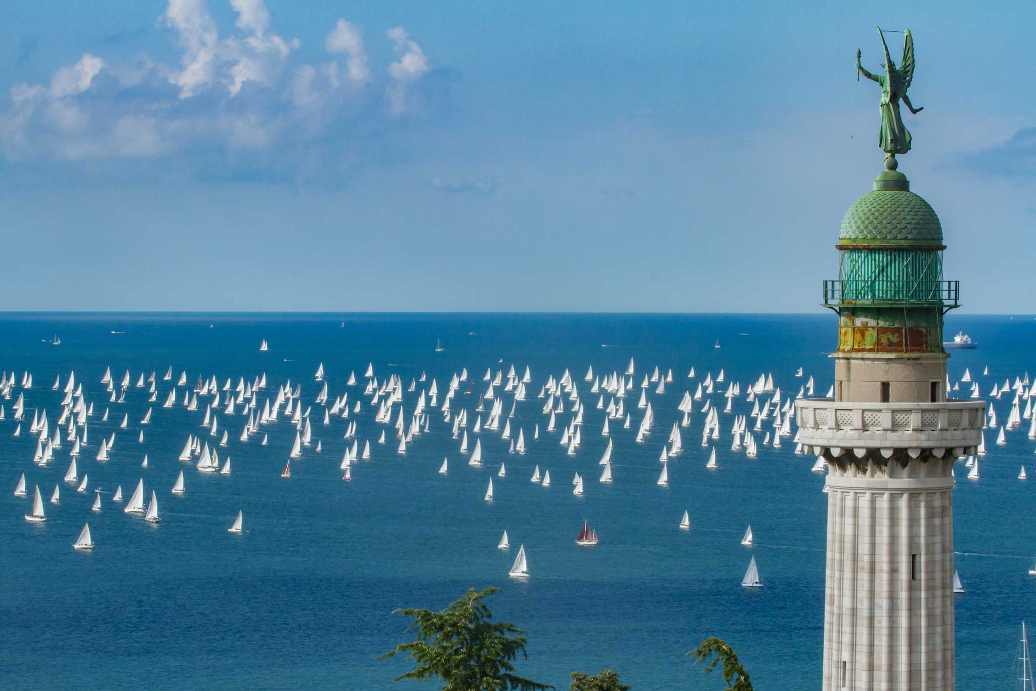 Hundreds of sailboats fill the Gulf of Trieste for the Barcolana, past the Victory Lighthouse.