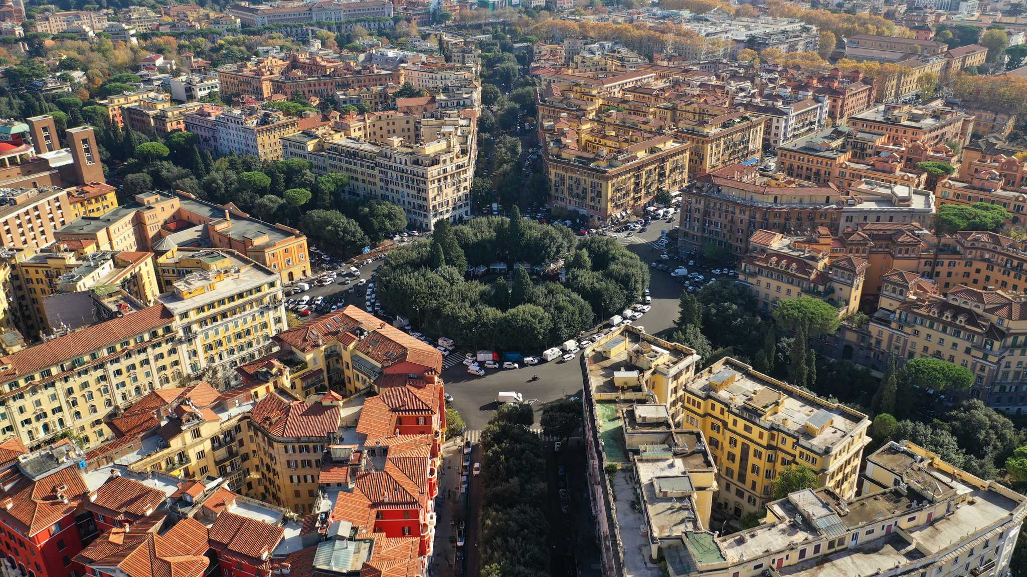 Aerial view of Prati's rooftops with St. Peter's Basilica dome and Rome beyond.