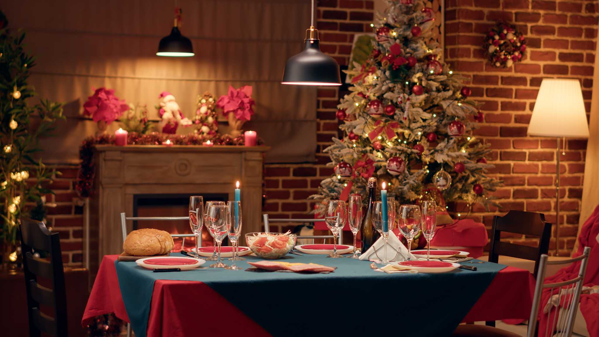 Lighted Christmas tablescape with decorated Christmas tree in the background.