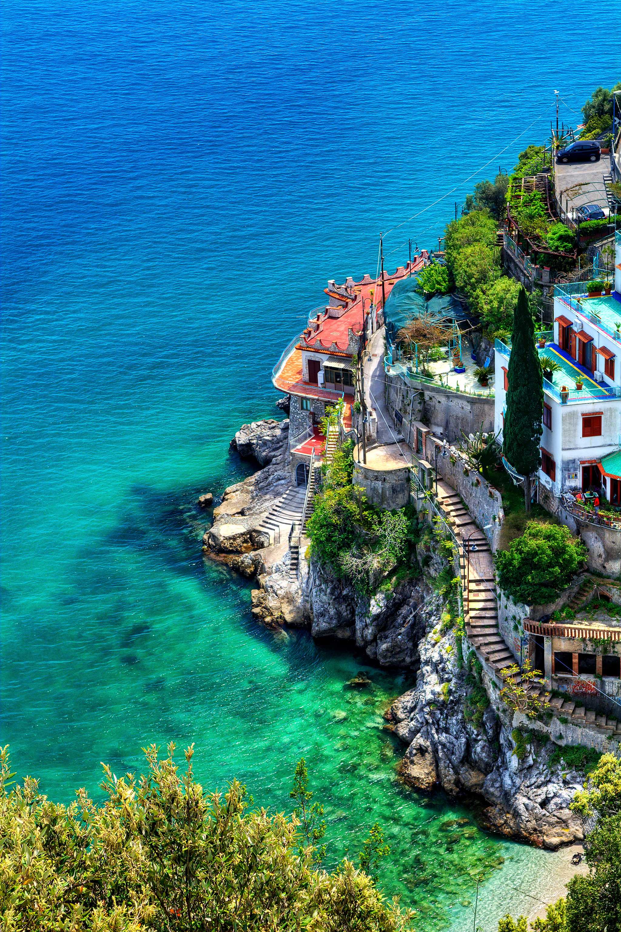 Vietri sul Mare coastal stairways and colorful homes beside bright blue sea.