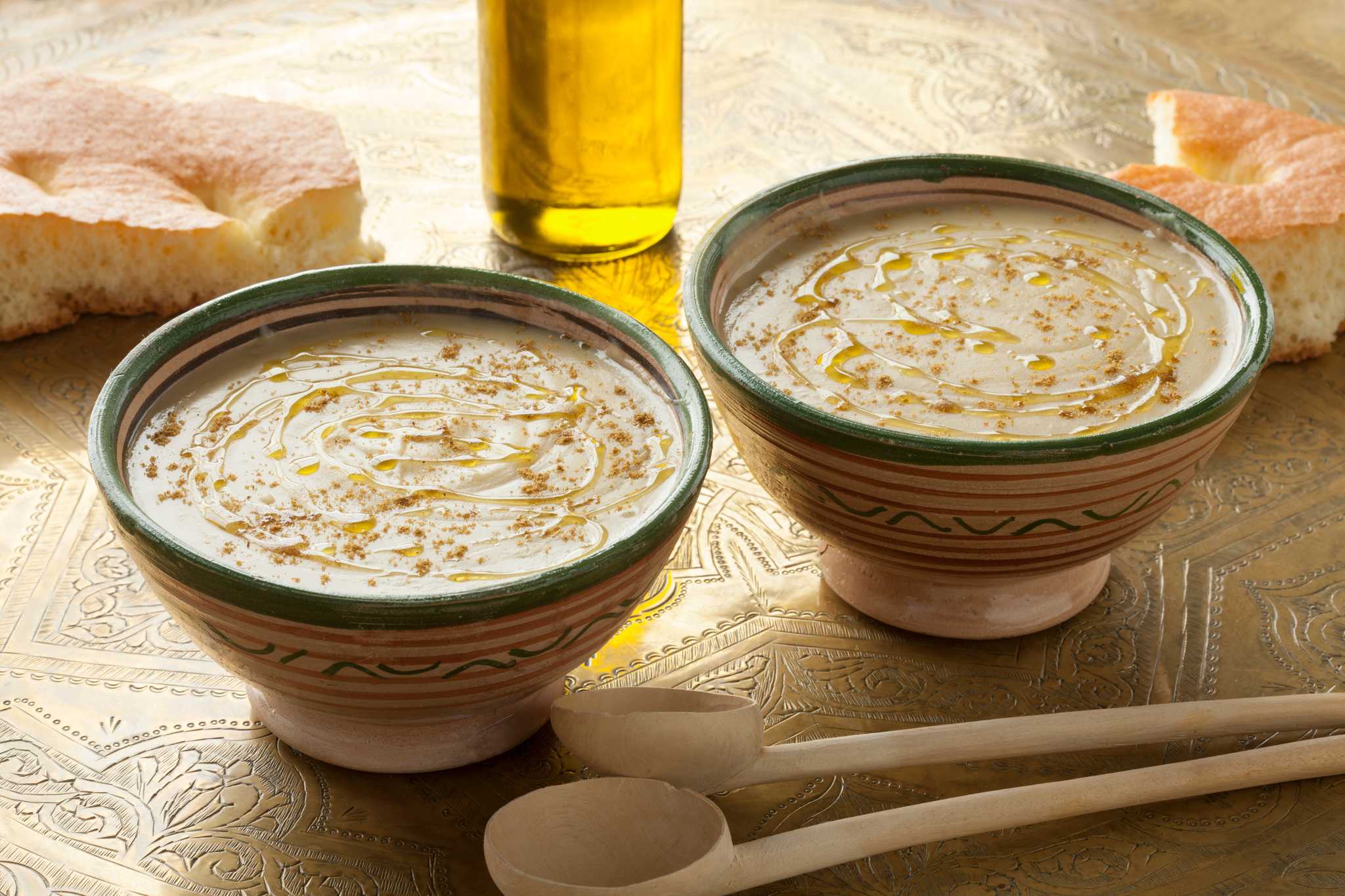 A creamy fava bean puree drizzled with olive oil and dusted with cumin, served with bread.