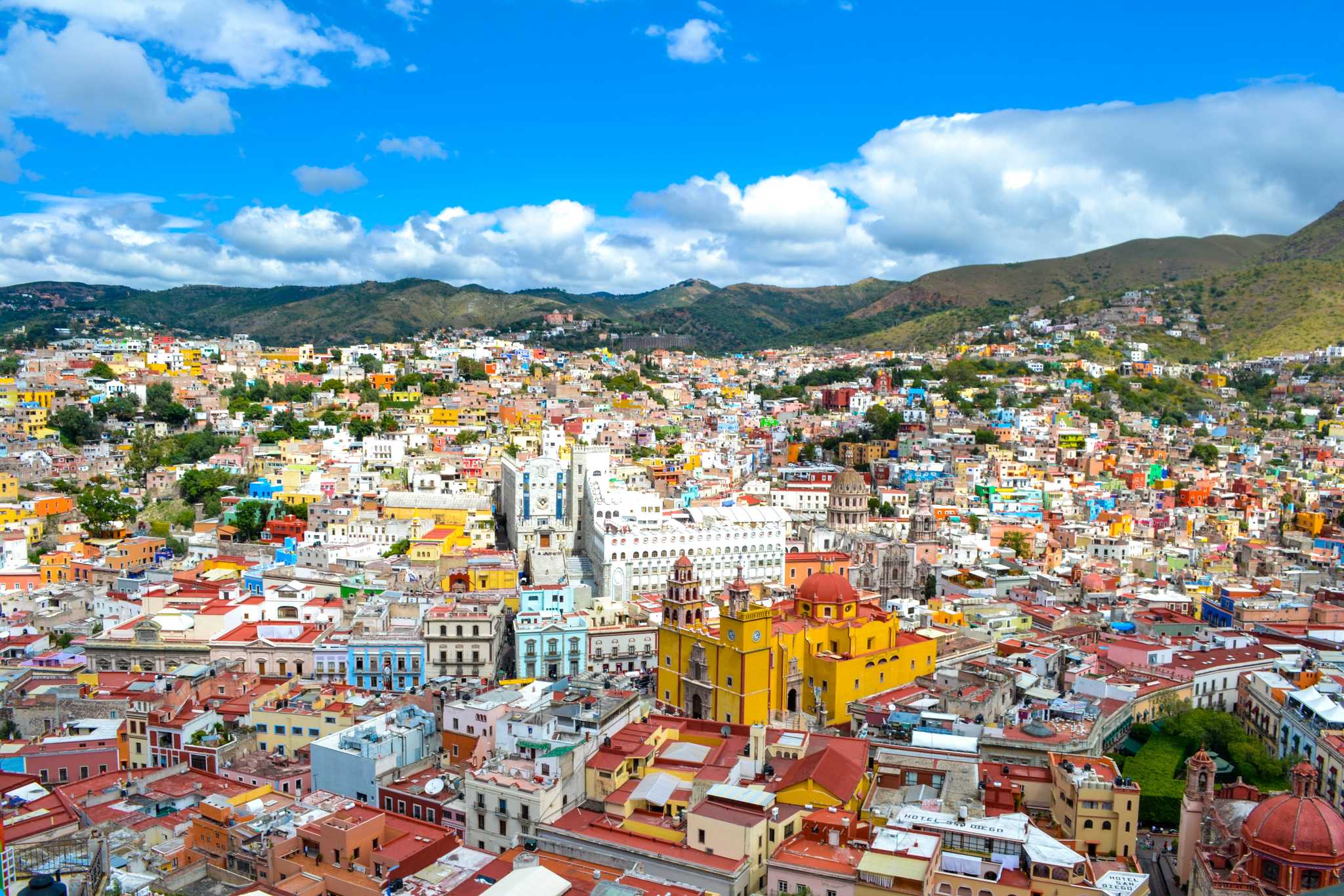 Distant shot of the colorful city of Guanajuato, the yellow basilica in the center.