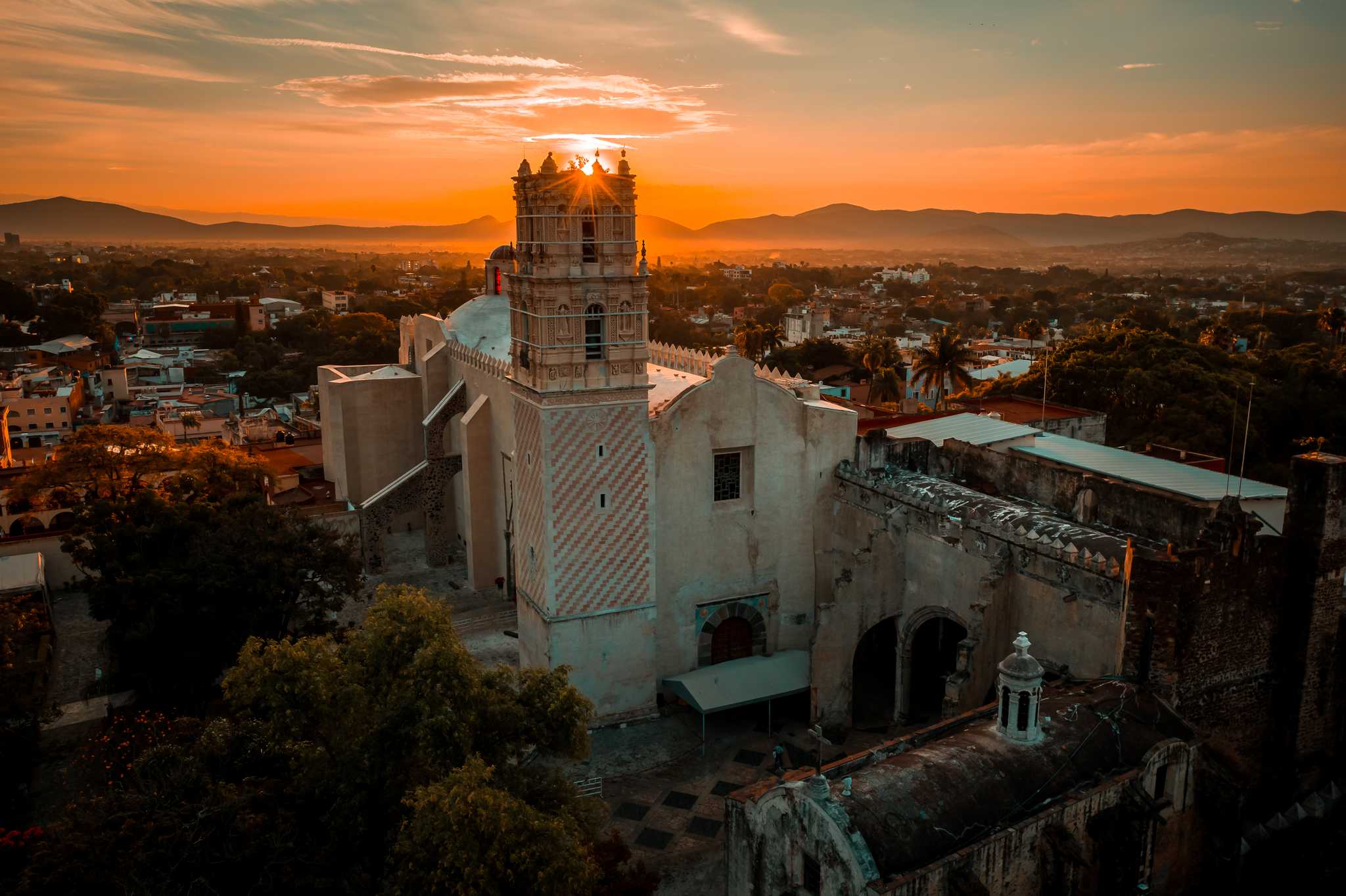 Warm orange sunrise over a cathedral in the center of Cuernavaca.