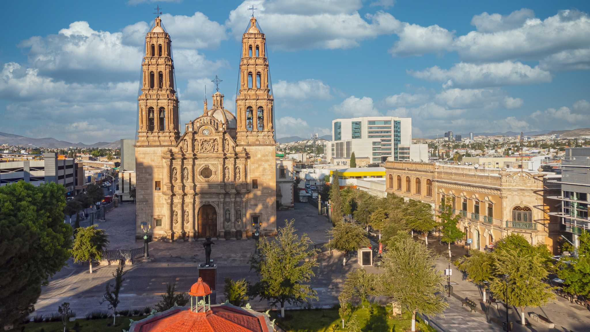 Baroque cathedral facade in the center of Chihuahua town square on a cloudy day.