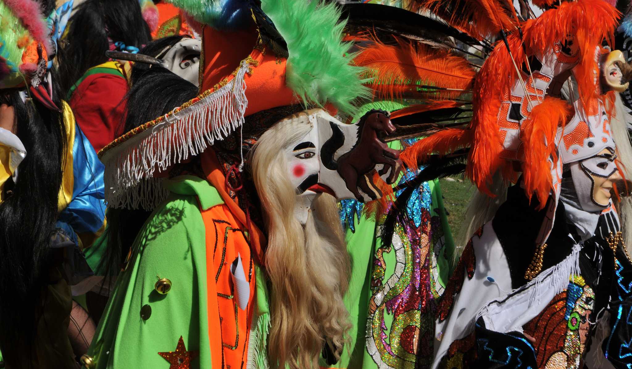 Masked dancers in feathers and sequined capes at Carnival in Huayacocotla, Veracruz.