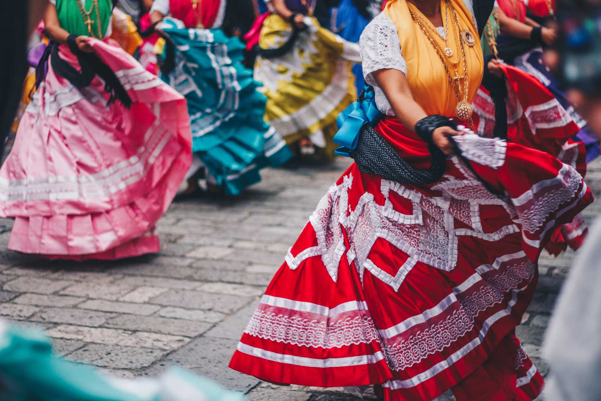 Dancers in bright ruffled skirts swirl through Oaxacaâs streets during Guelaguetza.
