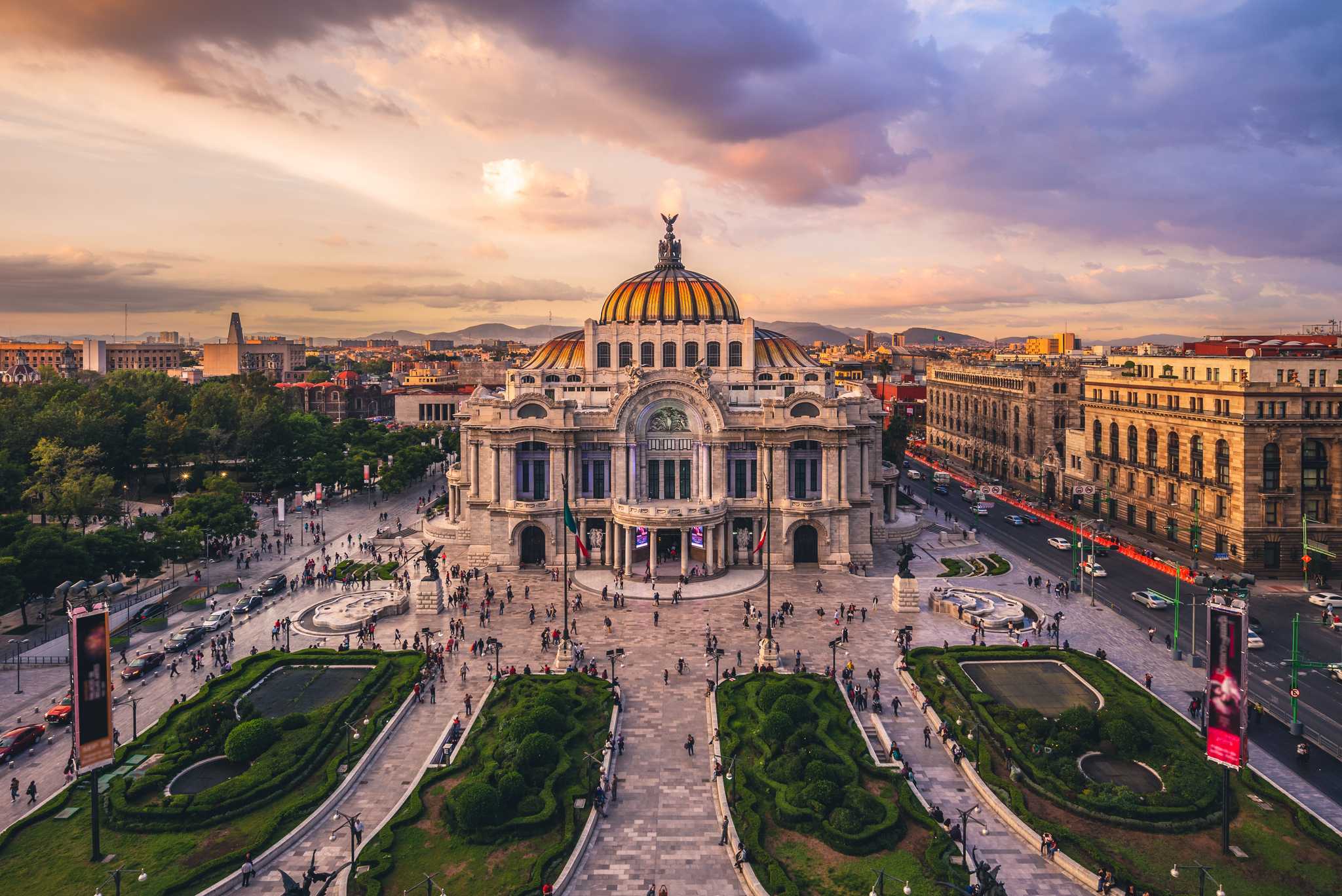 Sunset above the elaborate gold-domed palace of fine arts in Mexico City.