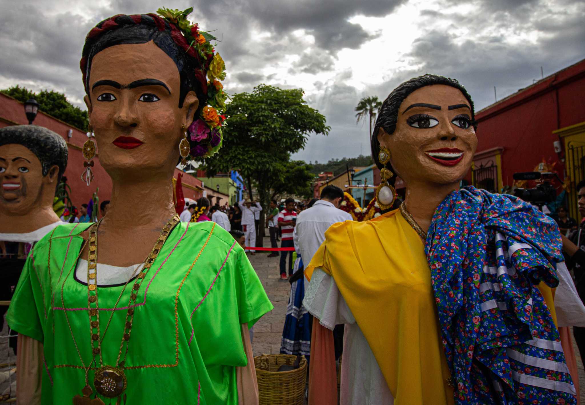 Giant hand-painted puppets of two women at a Calendas parade in Oaxaca, Mexico.