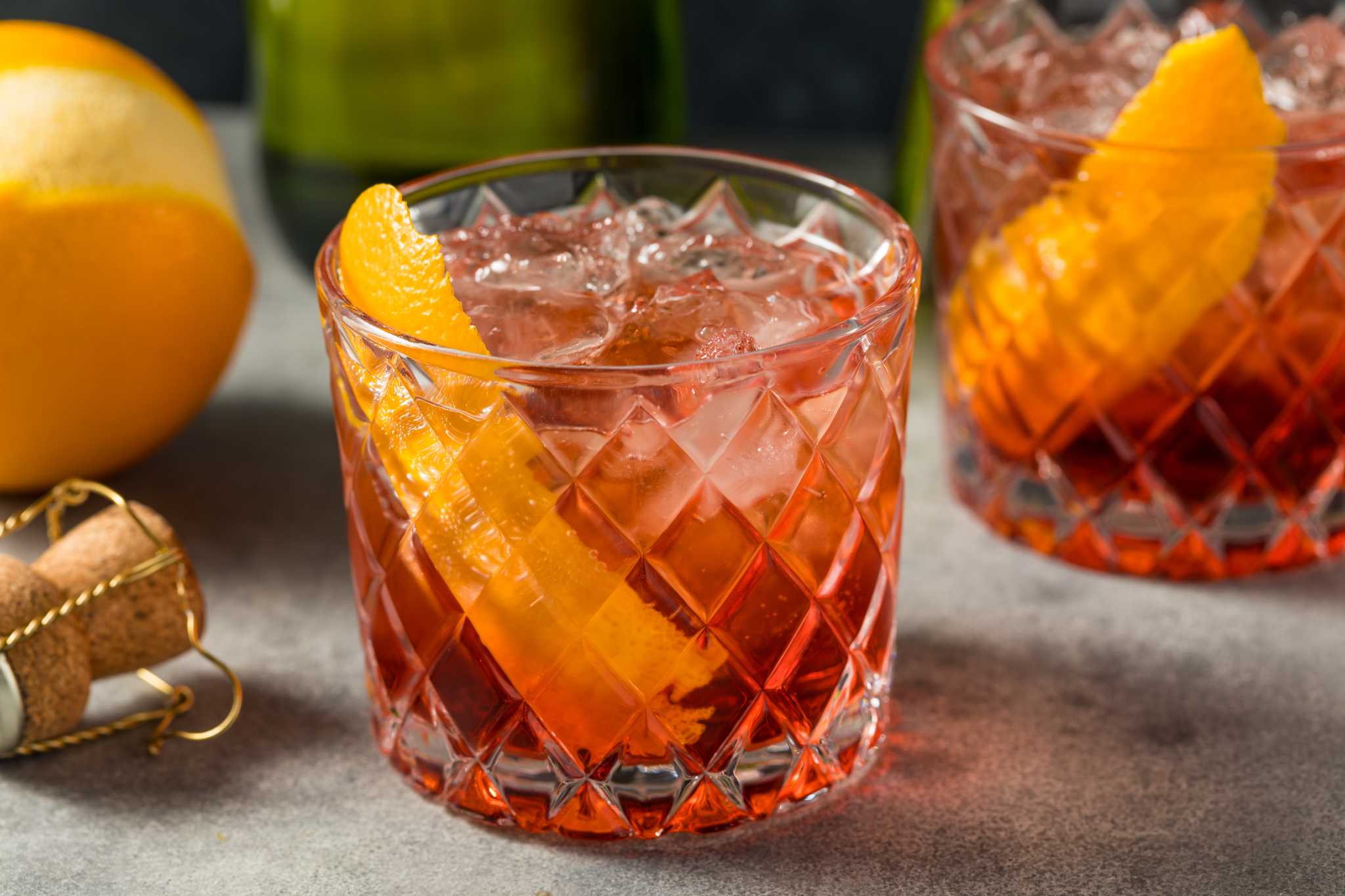 Close-up of a lowball glass with an orange peel and a negroni sbagliato.