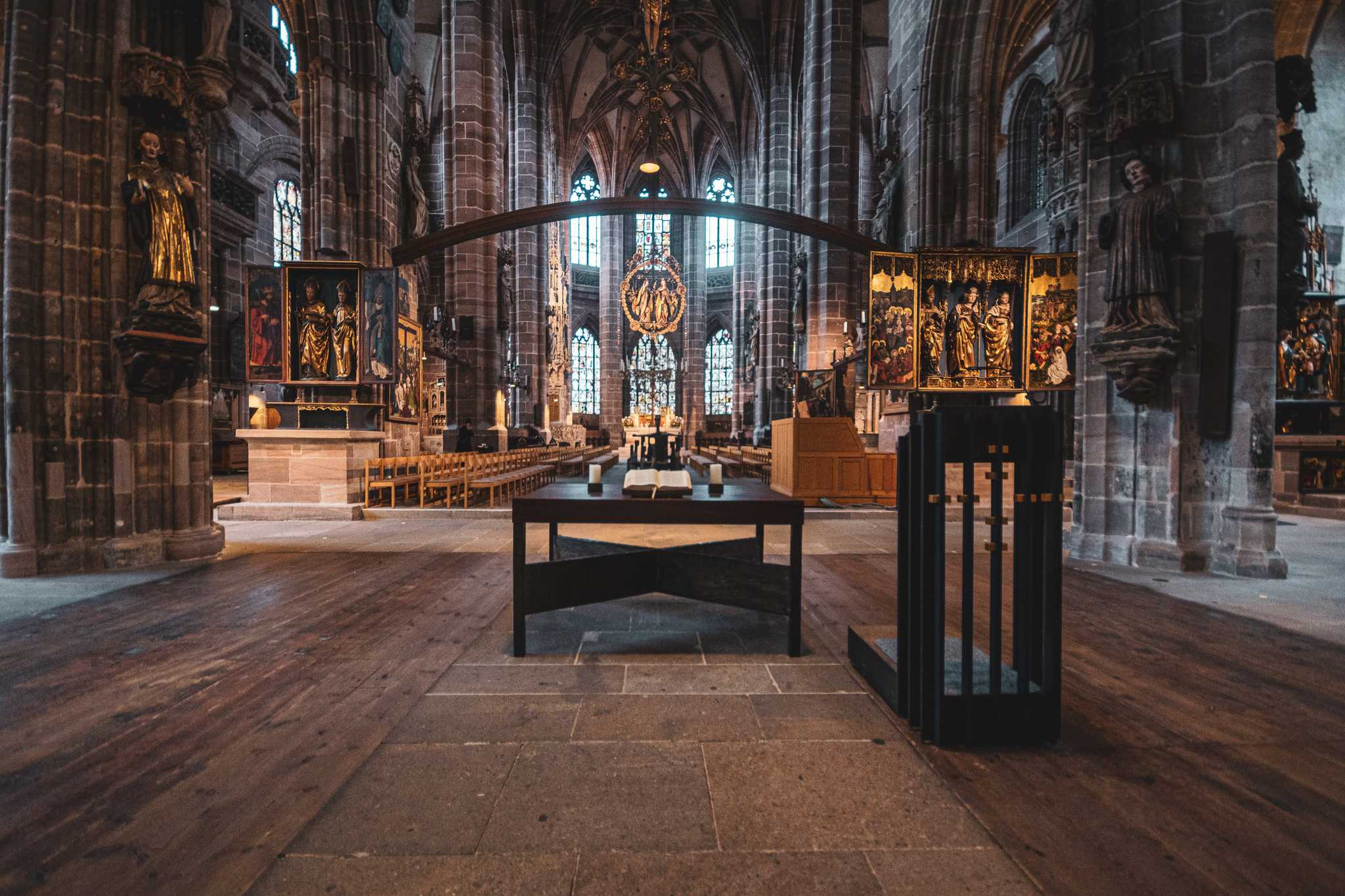 Interior of cathedral in Nuremberg, shot from the altar looking out at empty chairs.