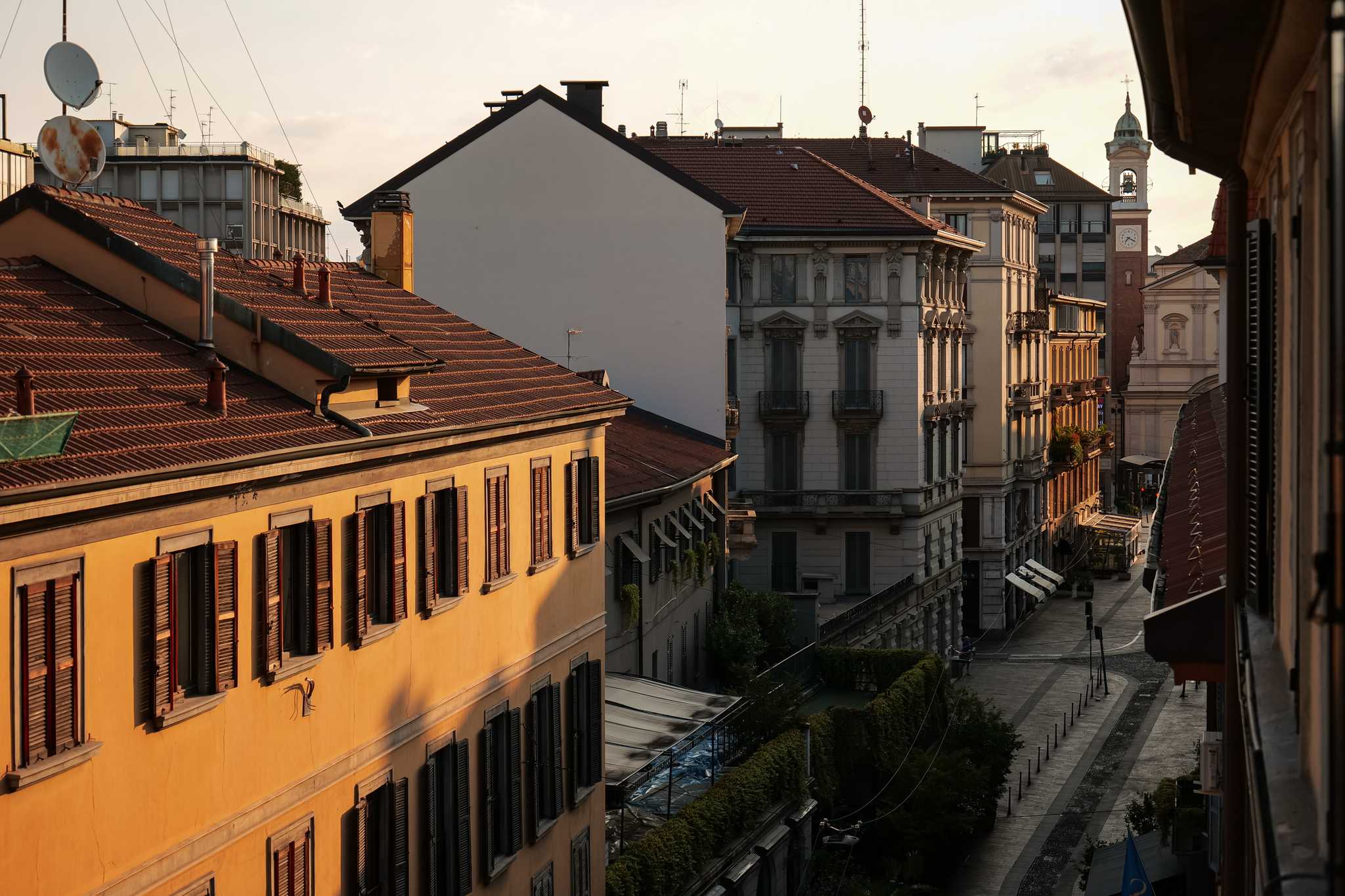 The quiet residential neighborhood street of Porto Venezia with early morning light.