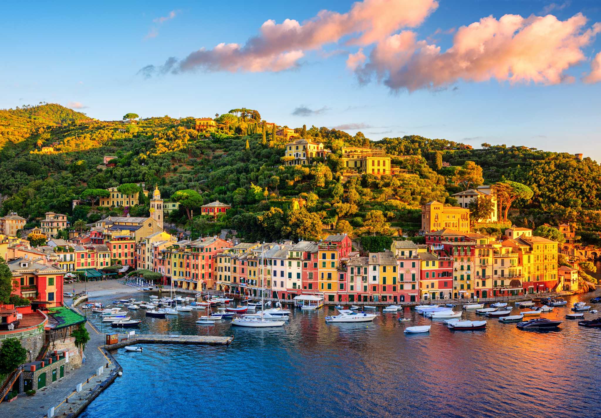 The Portofino bay below, lined with colorful buildings and the mountains behind.