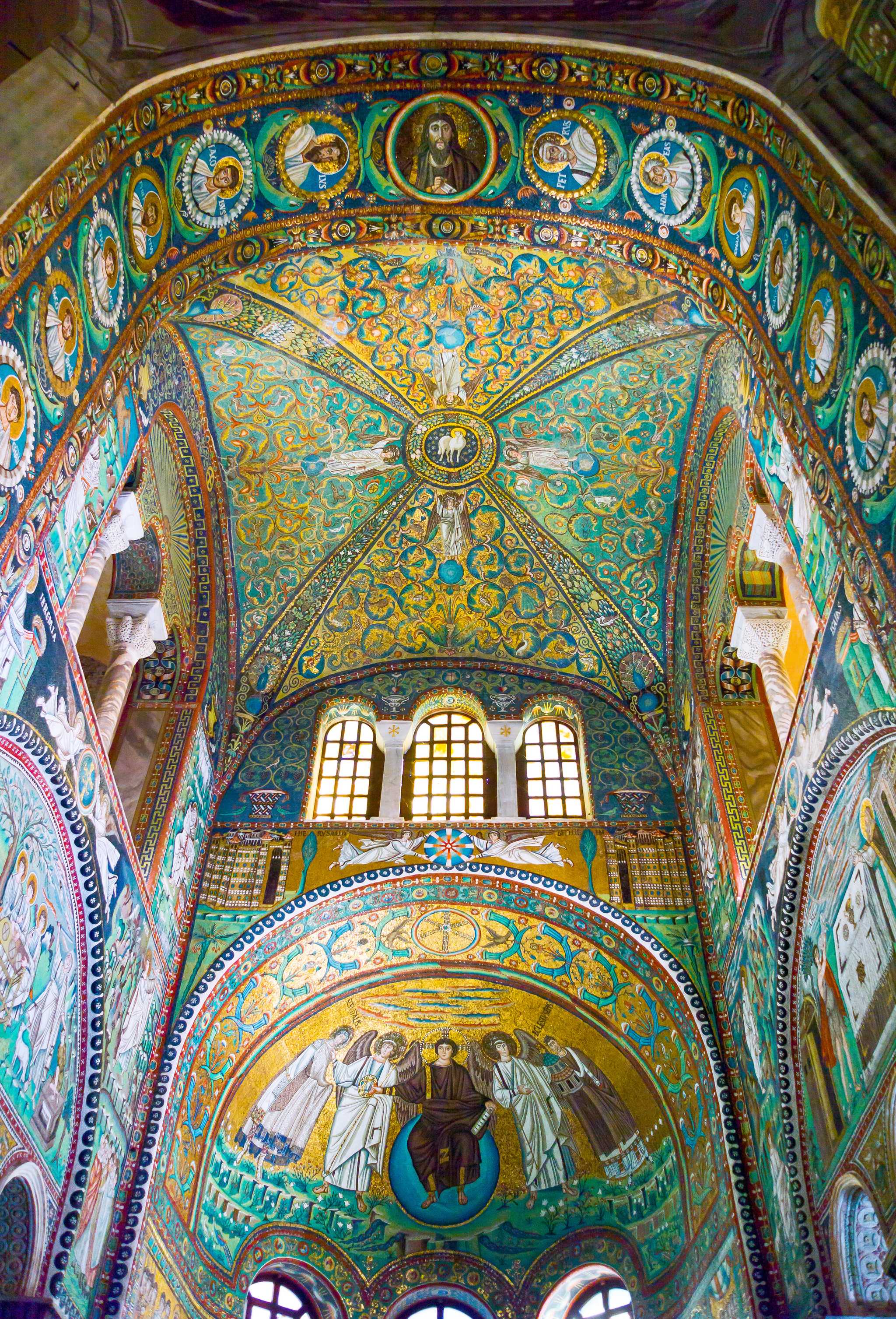 The gold and green Byzantine mosaics covering the vault and apse of the Basilica of San Vitale in Ravenna.
