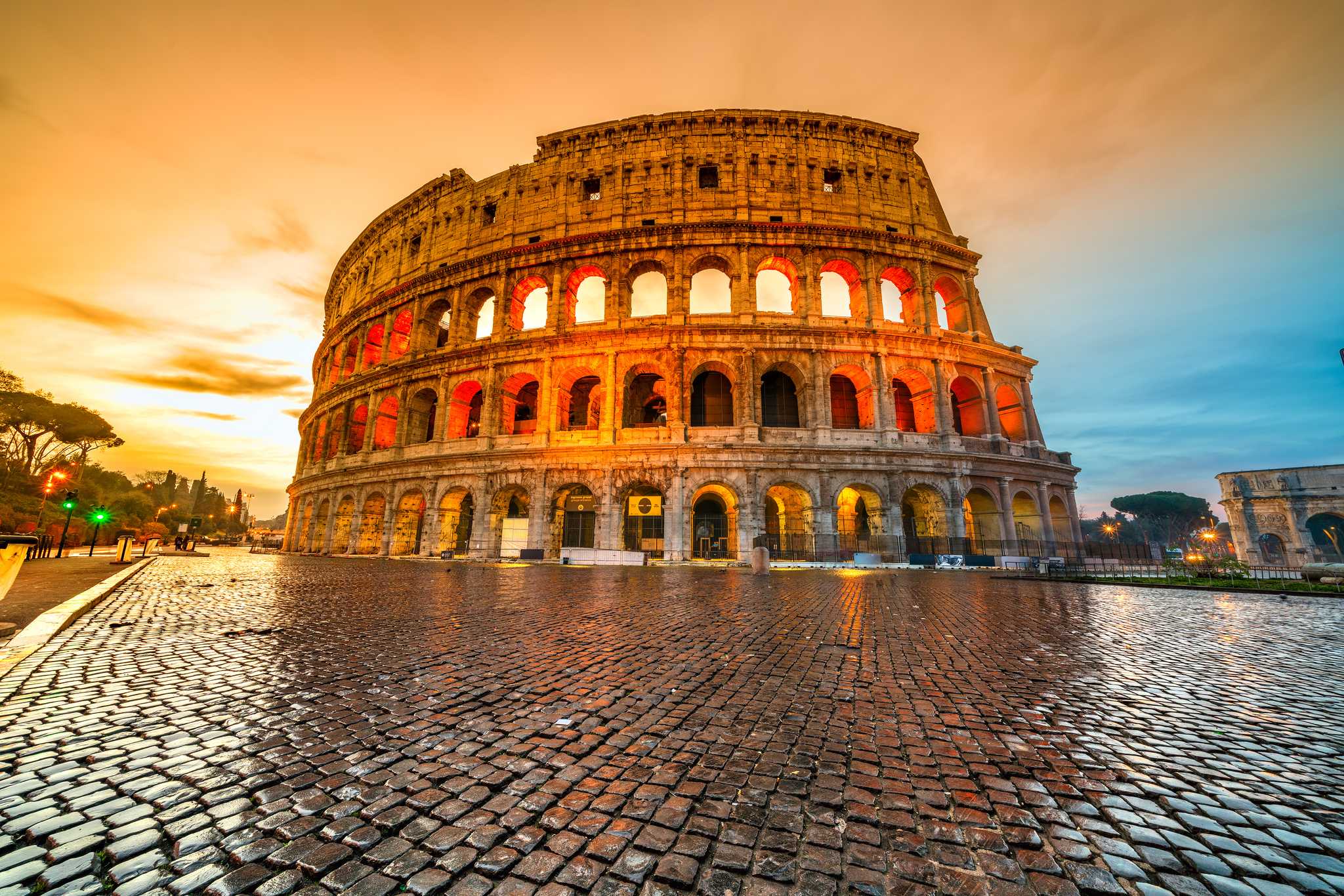 Rome’s Colosseum with shiny wet cobblestones in the foreground.