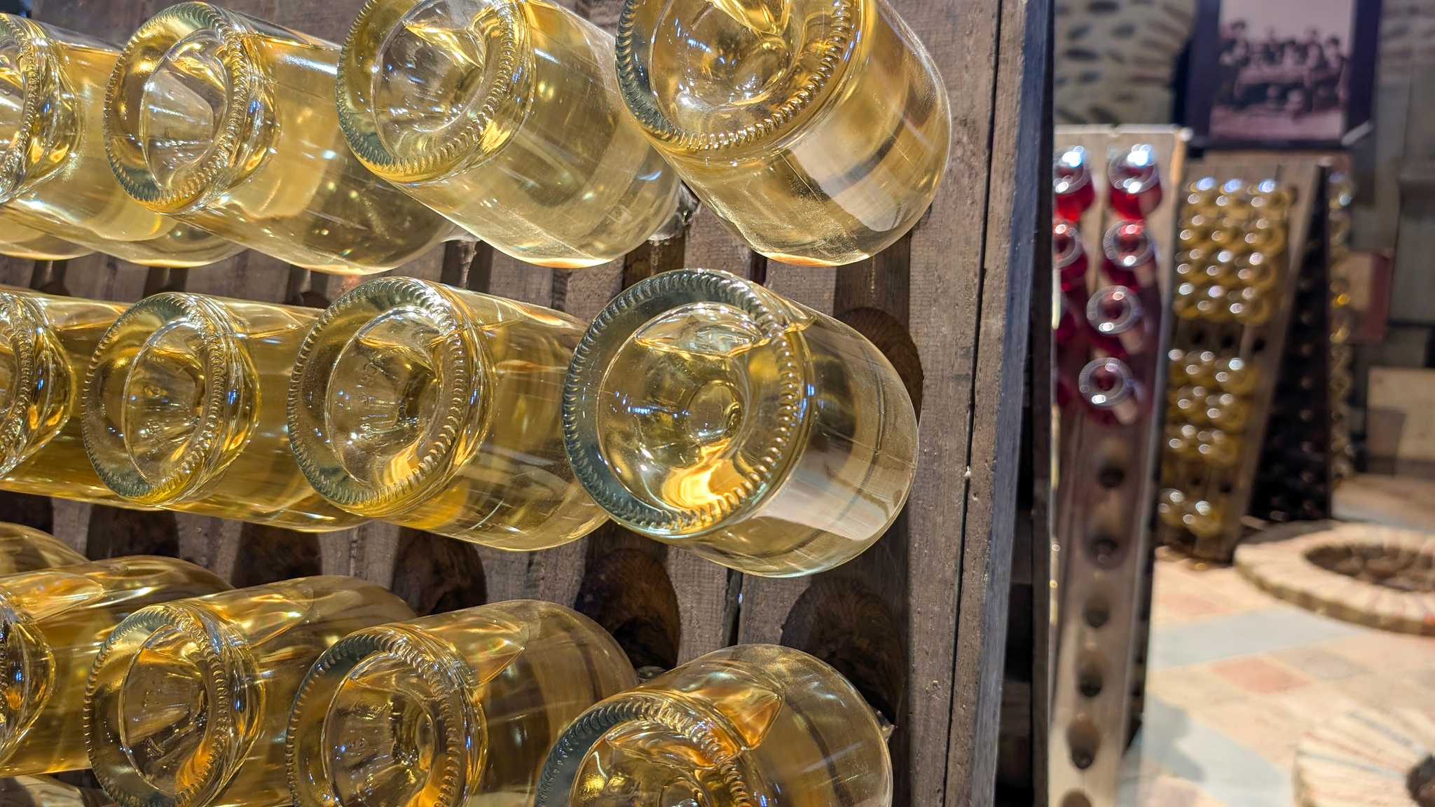 Bottle of pale yellow champagne in a cellar in Reims, France.