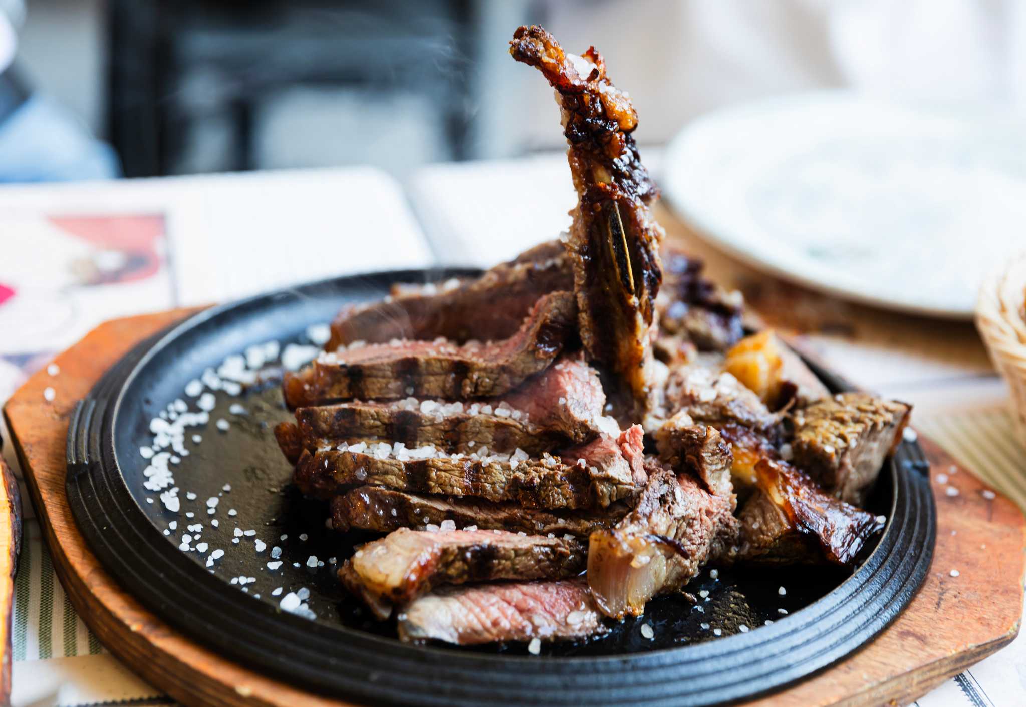 Bistecca alla Fiorentina, a Tuscan steak dish, served on a hot iron plate.