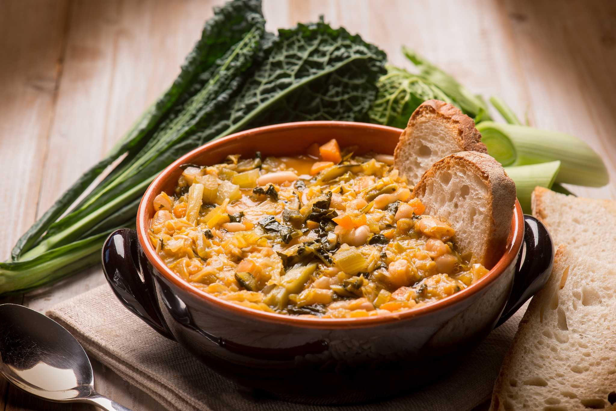 Tuscan ‘ribollita’ dish of bread and kale soup, served in a clay bowl.