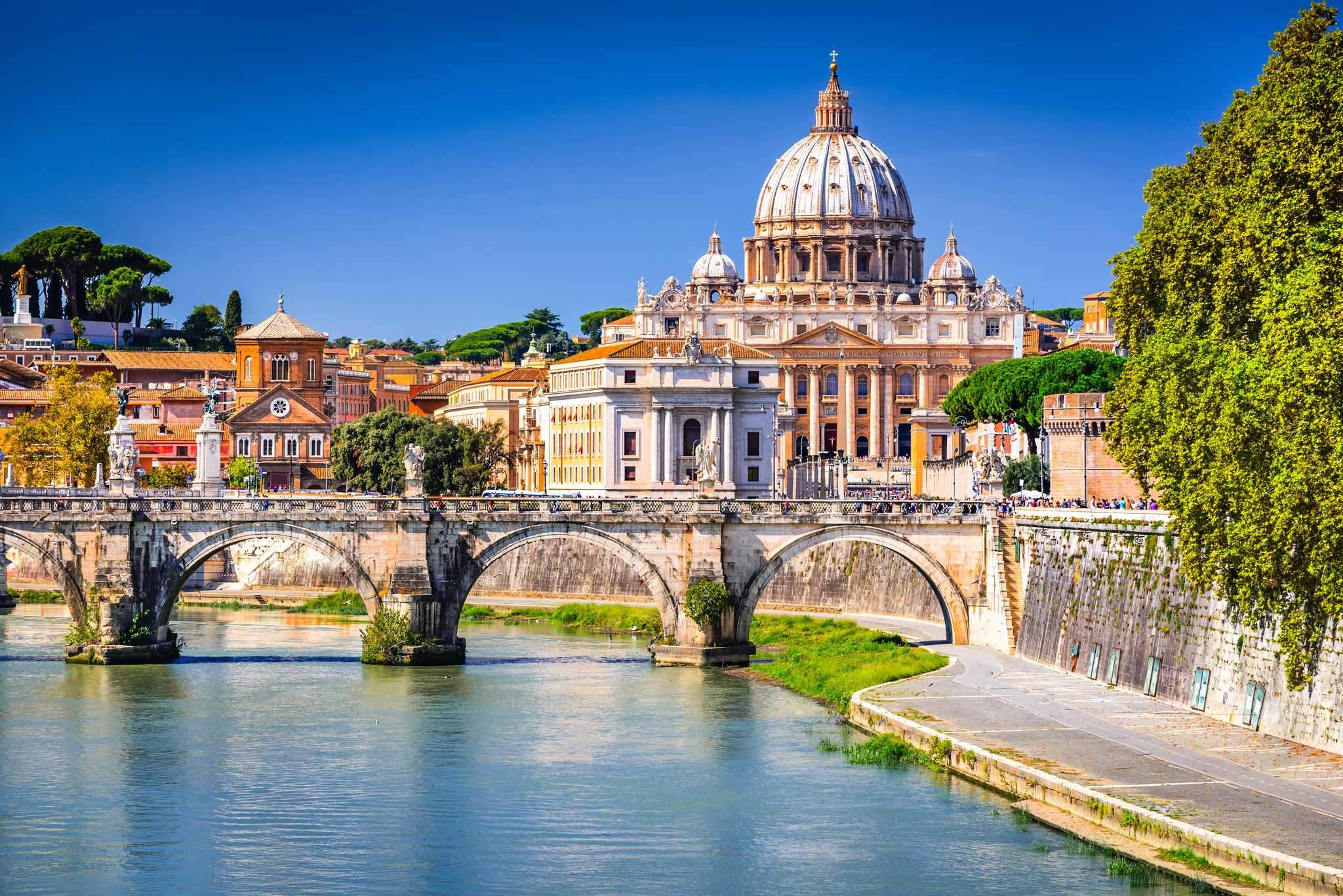 St. Peter’s Basilica in the Vatican in the background, with a bridge and canal in the foreground.