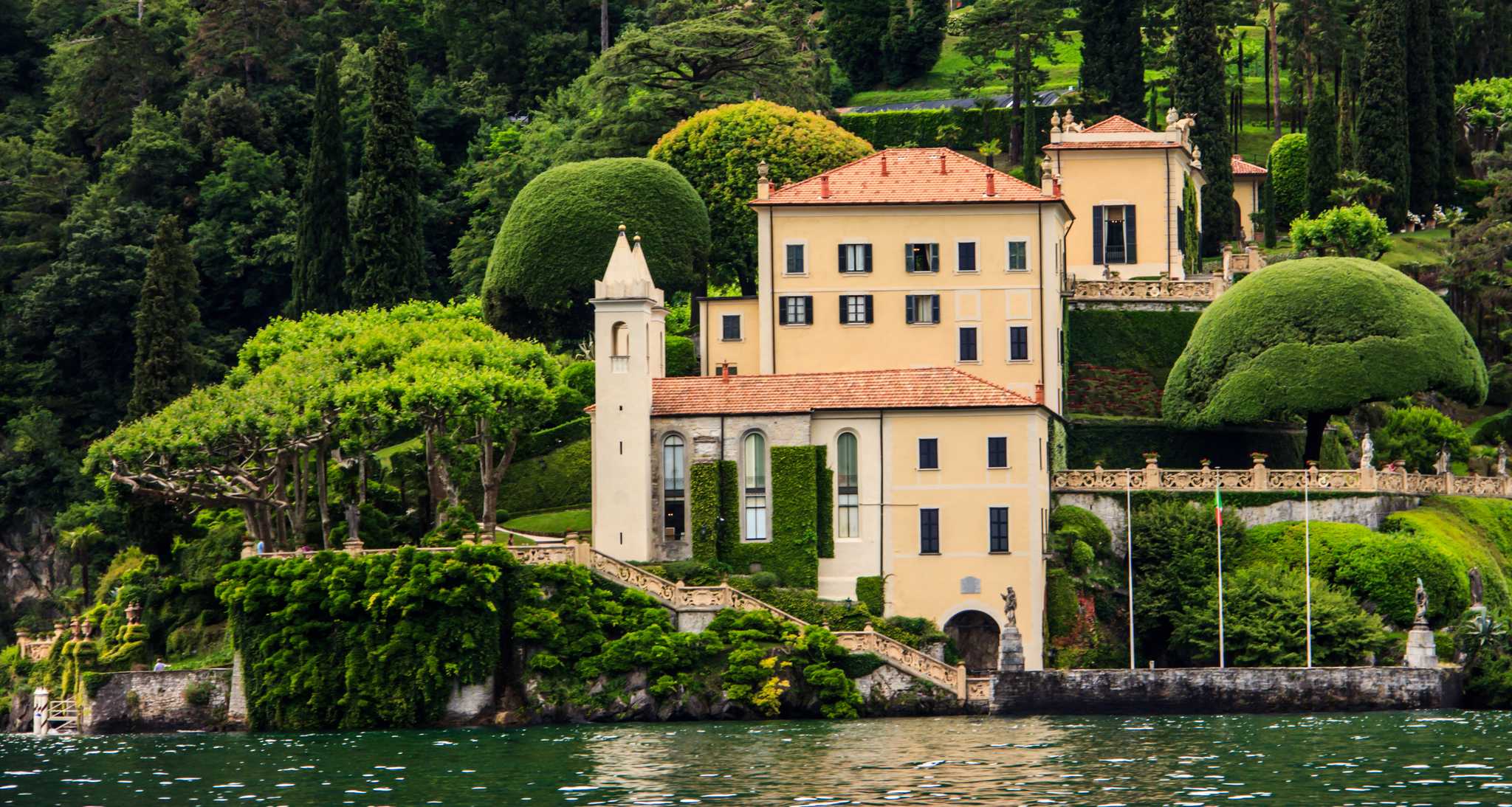Villa del Balbianello above Lake Como, with terraced gardens and sculpted trees.